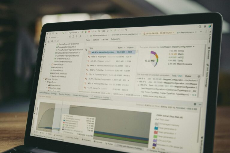A close-up view of a laptop screen showing a coding and data analysis software interface in an indoor setting.