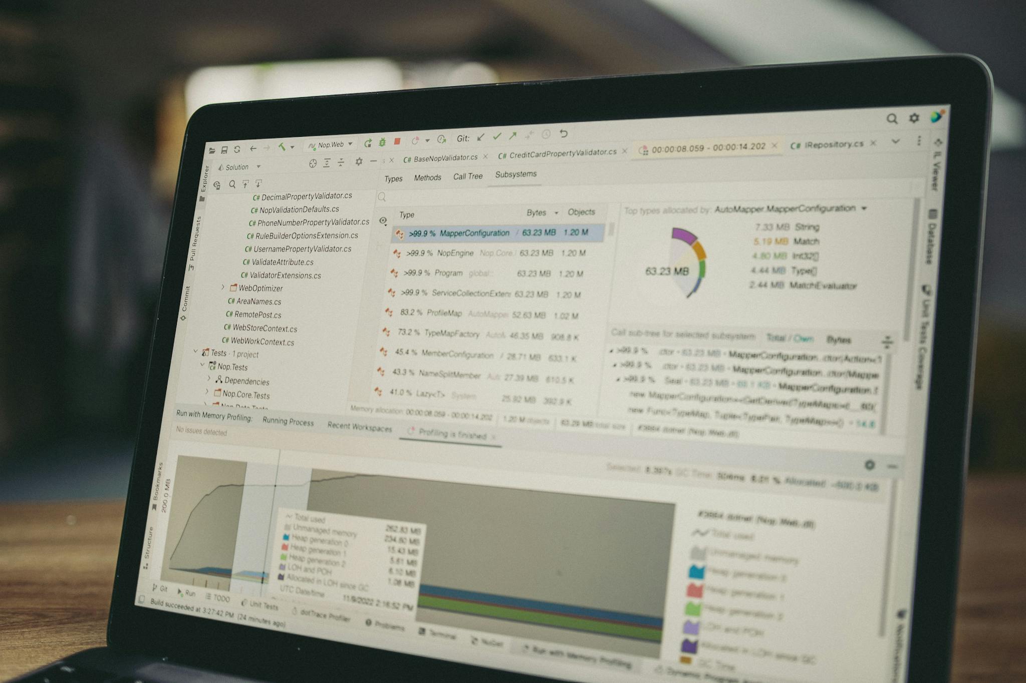 A close-up view of a laptop screen showing a coding and data analysis software interface in an indoor setting.